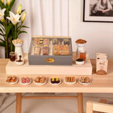 The Regal Treat Box gourmet gift basket featuring dry fruits, artisanal sweets, and tea, perfect for anniversaries and festive gifting.